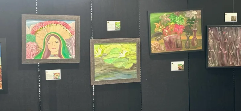 Four framed paintings including Our Lady with a flower halo, water lilies, and a vase of flowers.
